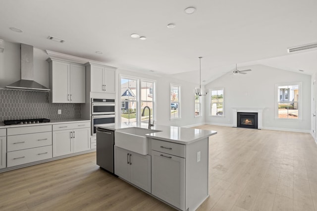 7507 Old Nashville Rd S, Fairview, TN 37062 - kitchen with wall chimney range hood, appliances with stainless steel finishes, ceiling fan, light countertops, and decorative backsplash