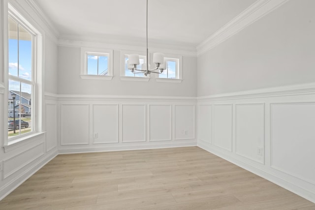 7507 Old Nashville Rd S, Fairview, TN 37062 - unfurnished dining area with a decorative wall, a chandelier, crown molding, light wood finished floors, and wainscoting