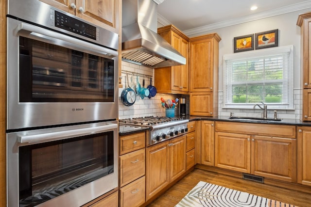 1470 Tyne Blvd, Nashville, TN 37215 - kitchen with wall chimney exhaust hood, appliances with stainless steel finishes, ornamental molding, decorative backsplash, and wood finished floors