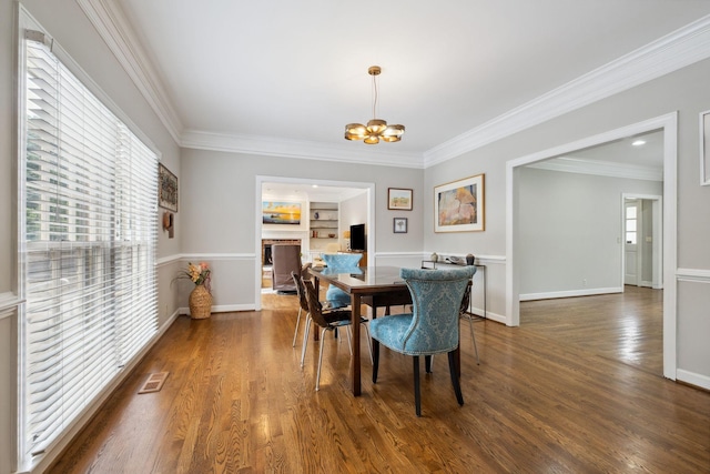 1470 Tyne Blvd, Nashville, TN 37215 - dining space with ornamental molding, a chandelier, wood finished floors, built in features, and a fireplace
