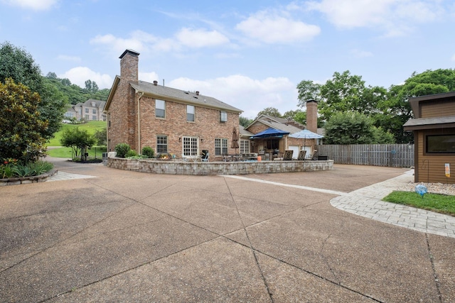 1470 Tyne Blvd, Nashville, TN 37215 - rear view of property with a patio, a chimney, and brick siding
