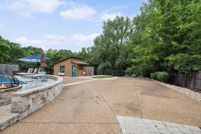 1470 Tyne Blvd, Nashville, TN 37215 - view of patio / terrace featuring an outdoor structure and a fire pit
