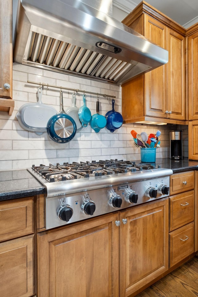 1470 Tyne Blvd, Nashville, TN 37215 - kitchen with wall chimney range hood, stainless steel gas stovetop, tasteful backsplash, and brown cabinetry
