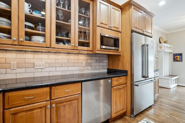 1470 Tyne Blvd, Nashville, TN 37215 - kitchen featuring appliances with stainless steel finishes, crown molding, light wood finished floors, backsplash, and glass insert cabinets