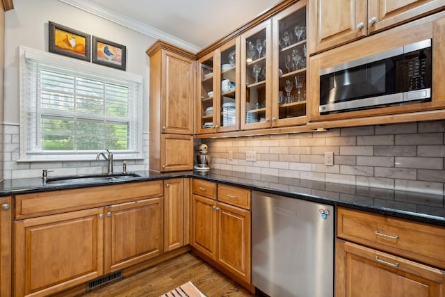 1470 Tyne Blvd, Nashville, TN 37215 - kitchen featuring stainless steel appliances, ornamental molding, wood finished floors, backsplash, and glass insert cabinets