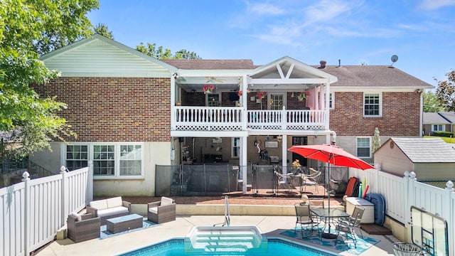 605 Jackson Ave, Carthage, TN 37030 - rear view of property with a balcony, a fenced backyard, brick siding, and a patio area