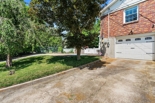 605 Jackson Ave, Carthage, TN 37030 - view of home's exterior with a garage, driveway, and brick siding