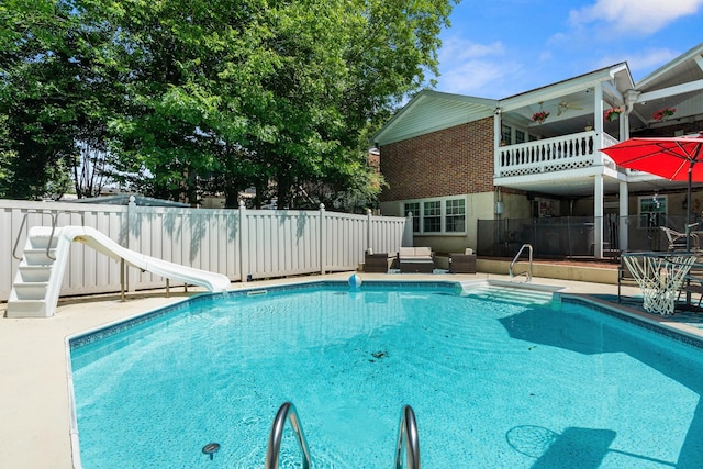 605 Jackson Ave, Carthage, TN 37030 - view of swimming pool featuring a water slide, a fenced backyard, ceiling fan, a patio area, and an outdoor hangout area