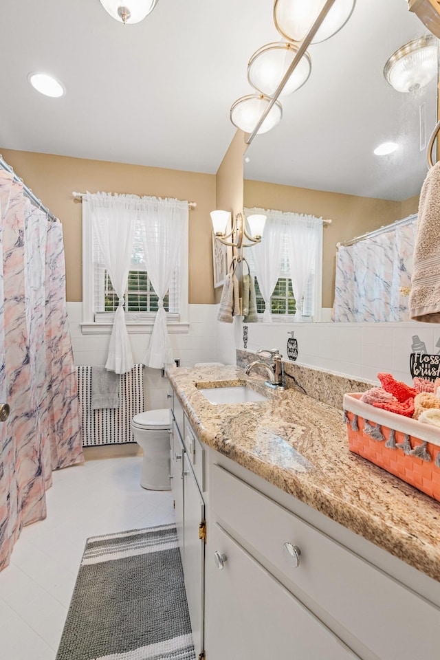 605 Jackson Ave, Carthage, TN 37030 - bathroom featuring tile walls, vanity, a wainscoted wall, and a shower with shower curtain