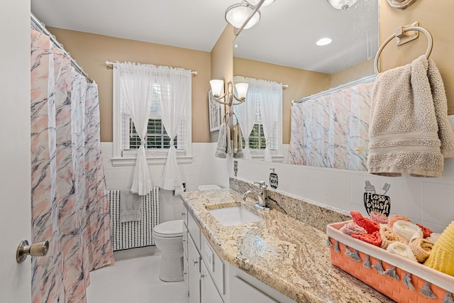605 Jackson Ave, Carthage, TN 37030 - full bath with plenty of natural light, tile walls, vanity, a wainscoted wall, and a shower with curtain