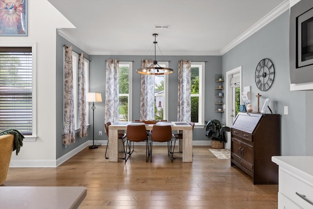 1588 Cobbler Ct, Chattanooga, TN 37421 - dining area featuring light wood-style floors, crown molding, and a chandelier
