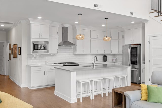 1588 Cobbler Ct, Chattanooga, TN 37421 - kitchen with wall chimney range hood, appliances with stainless steel finishes, light countertops, a kitchen breakfast bar, and white cabinetry
