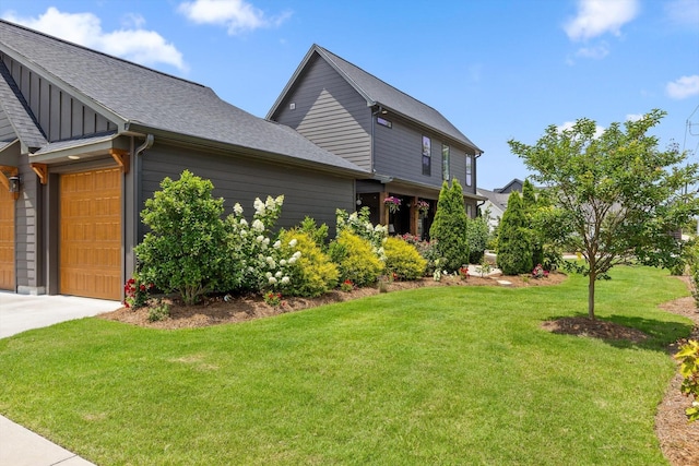 1588 Cobbler Ct, Chattanooga, TN 37421 - view of property exterior with a yard, an attached garage, board and batten siding, a shingled roof, and driveway