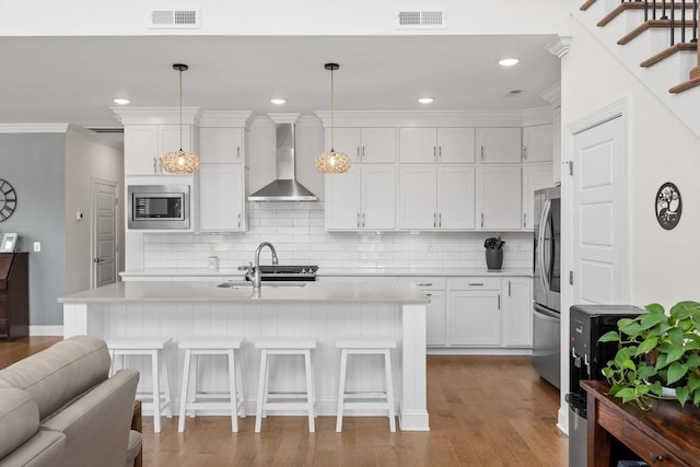 1588 Cobbler Ct, Chattanooga, TN 37421 - kitchen with wall chimney range hood, stainless steel appliances, light countertops, decorative backsplash, and white cabinetry