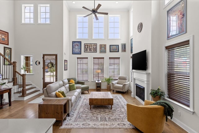 1588 Cobbler Ct, Chattanooga, TN 37421 - living room with a towering ceiling, ceiling fan, a fireplace, stairway, and wood finished floors