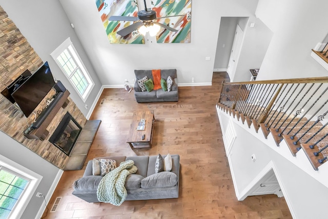267 Alonzo Pl, Cunningham, TN 37052 - living room with a fireplace, a ceiling fan, a high ceiling, plenty of natural light, and wood finished floors