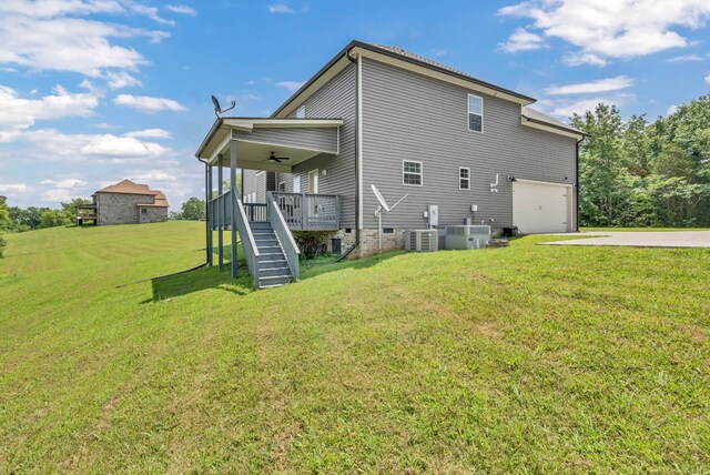 267 Alonzo Pl, Cunningham, TN 37052 - rear view of property with stairway, ceiling fan, a garage, concrete driveway, and a lawn