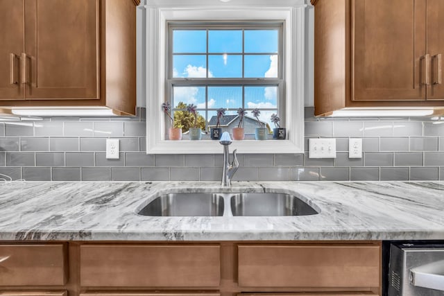 267 Alonzo Pl, Cunningham, TN 37052 - kitchen featuring brown cabinets, light stone countertops, and decorative backsplash