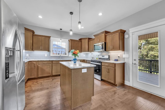 267 Alonzo Pl, Cunningham, TN 37052 - kitchen with appliances with stainless steel finishes, healthy amount of natural light, brown cabinetry, tasteful backsplash, and recessed lighting