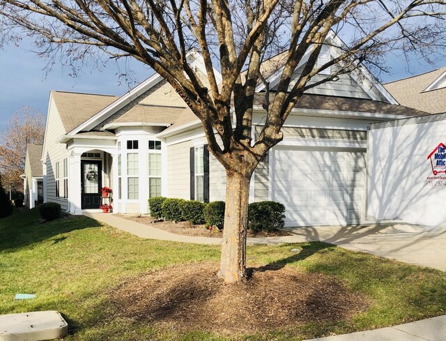602 Brigadier St, Mount Juliet, TN 37122 - view of front facade featuring an attached garage, roof with shingles, a front yard, and concrete driveway