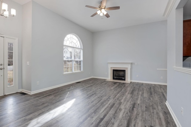 3044 Stone Bridge Rd, Antioch, TN 37013 - unfurnished living room with dark wood-style flooring, a ceiling fan, and a fireplace with flush hearth