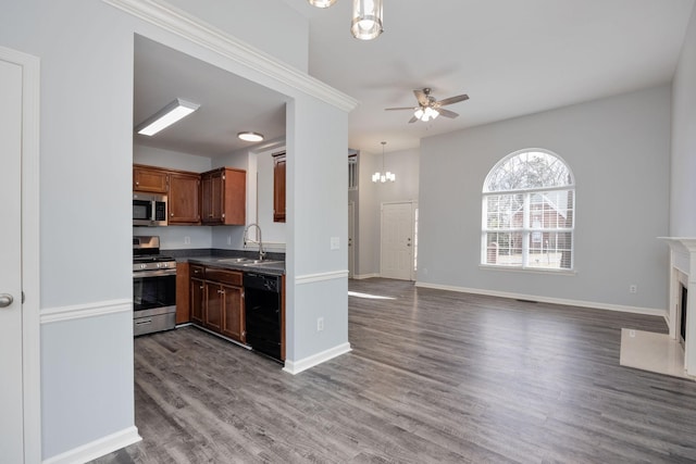 3044 Stone Bridge Rd, Antioch, TN 37013 - kitchen with appliances with stainless steel finishes, a chandelier, ceiling fan, dark wood finished floors, and dark countertops