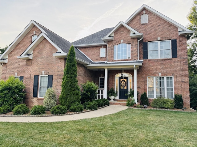 152 Yorkshire Dr, Clarksville, TN 37043 - traditional-style home with brick siding, a front yard, and a shingled roof