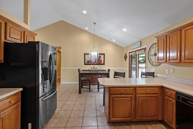 2007 New Castle Rd, Spring Hill, TN 37174 - kitchen featuring black appliances, lofted ceiling, a peninsula, brown cabinets, and light countertops