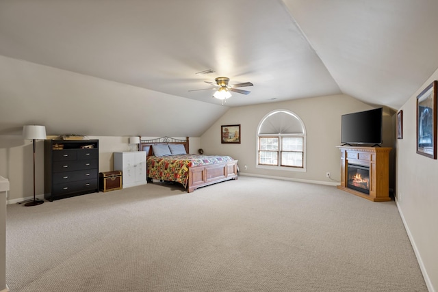 2007 New Castle Rd, Spring Hill, TN 37174 - carpeted bedroom with vaulted ceiling, a glass covered fireplace, and a ceiling fan