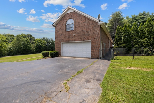 2007 New Castle Rd, Spring Hill, TN 37174 - view of property exterior with a garage, driveway, brick siding, and a gate