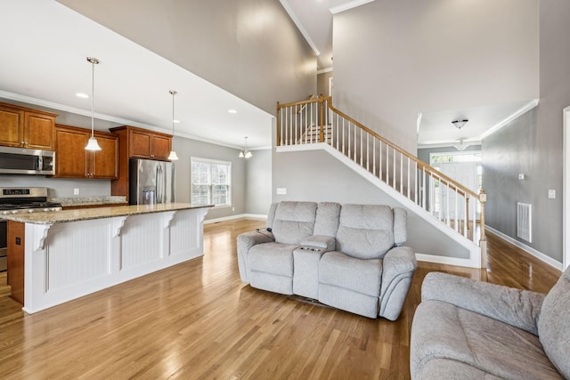 8005 Ragusa Cir, Spring Hill, TN 37174 - living room with crown molding, light wood-style floors, stairway, recessed lighting, and a towering ceiling