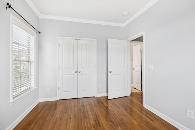 8005 Ragusa Cir, Spring Hill, TN 37174 - unfurnished bedroom featuring crown molding, wood finished floors, multiple windows, and a closet