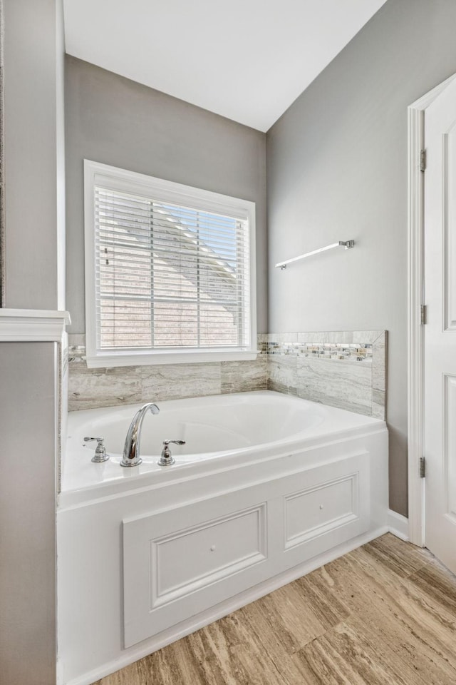 8005 Ragusa Cir, Spring Hill, TN 37174 - bathroom featuring wood finished floors and a garden tub