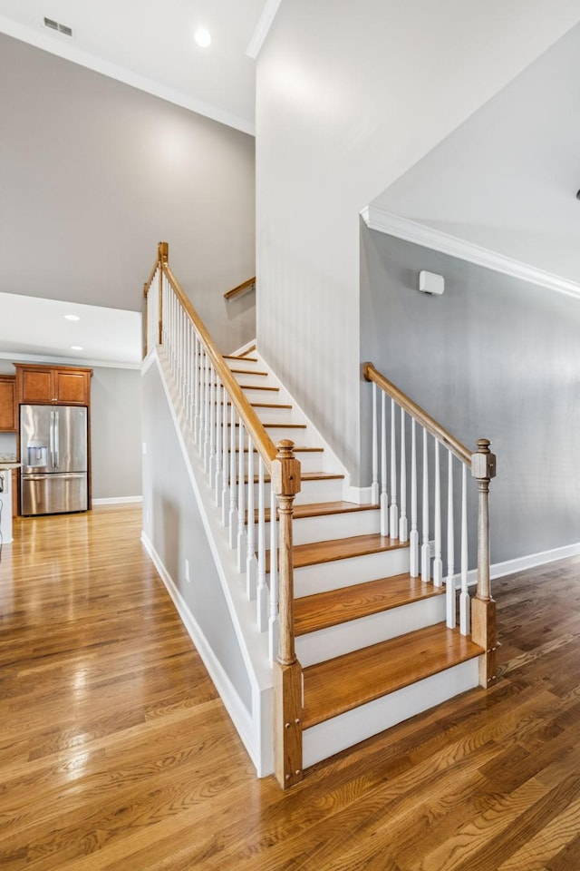 8005 Ragusa Cir, Spring Hill, TN 37174 - staircase with wood finished floors, ornamental molding, and recessed lighting