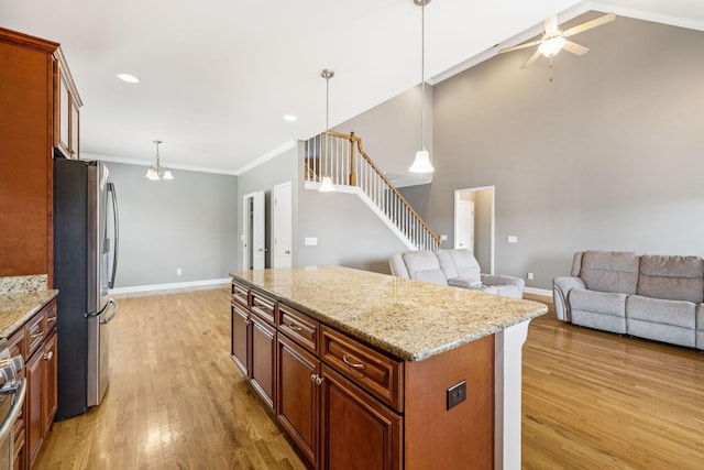 8005 Ragusa Cir, Spring Hill, TN 37174 - kitchen featuring freestanding refrigerator, light wood-type flooring, a kitchen island, ceiling fan, and open floor plan