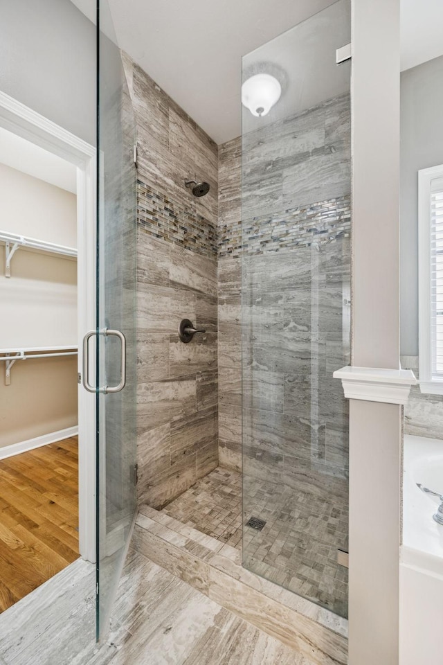 8005 Ragusa Cir, Spring Hill, TN 37174 - full bath with a shower stall, wood finished floors, a walk in closet, and a tub