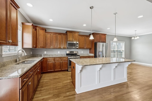 8005 Ragusa Cir, Spring Hill, TN 37174 - kitchen featuring appliances with stainless steel finishes, a breakfast bar, a kitchen island, ornamental molding, and light wood-style flooring