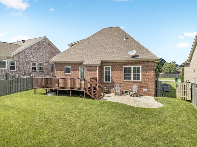 8005 Ragusa Cir, Spring Hill, TN 37174 - rear view of house featuring a fenced backyard, a patio area, roof with shingles, a wooden deck, and brick siding