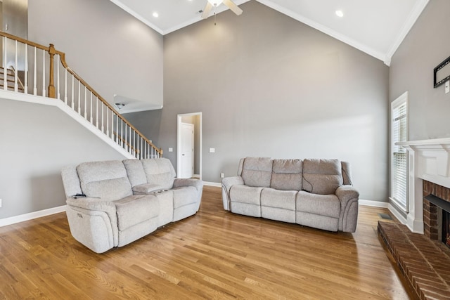 8005 Ragusa Cir, Spring Hill, TN 37174 - living area with crown molding, stairs, a ceiling fan, high vaulted ceiling, and light wood-type flooring