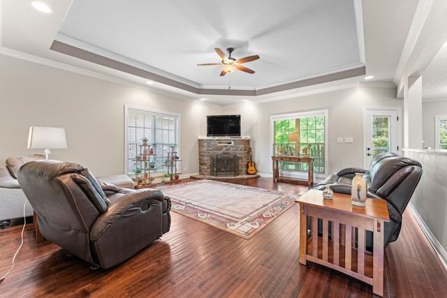 2950 Prince Dr, Clarksville, TN 37043 - living area featuring a tray ceiling, ceiling fan, dark wood-style flooring, a fireplace, and ornamental molding