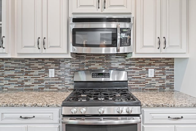 2950 Prince Dr, Clarksville, TN 37043 - kitchen featuring stainless steel appliances, white cabinets, and decorative backsplash