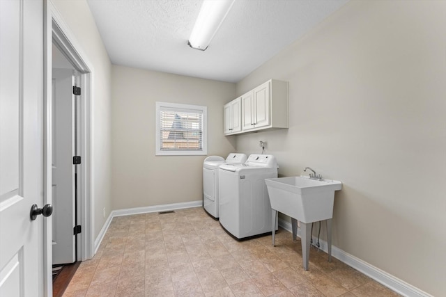 2950 Prince Dr, Clarksville, TN 37043 - washroom with washing machine and dryer, cabinet space, and a textured ceiling