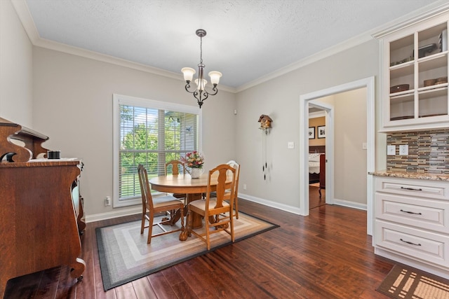 2950 Prince Dr, Clarksville, TN 37043 - dining room featuring dark wood-type flooring, crown molding, a chandelier, and a textured ceiling