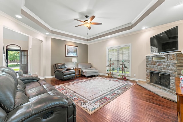 2950 Prince Dr, Clarksville, TN 37043 - living area featuring a tray ceiling, a ceiling fan, a stone fireplace, crown molding, and hardwood / wood-style flooring