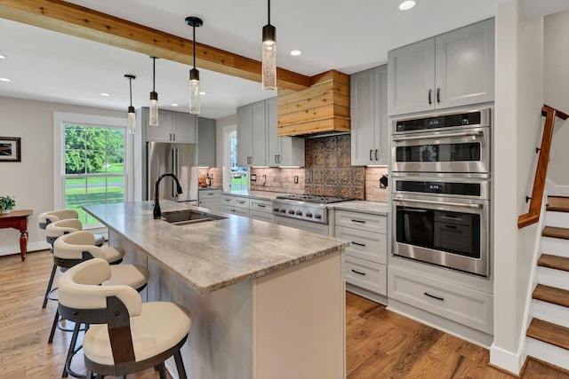 9003 Oden Ct, Brentwood, TN 37027 - kitchen with appliances with stainless steel finishes, gray cabinetry, premium range hood, backsplash, and recessed lighting