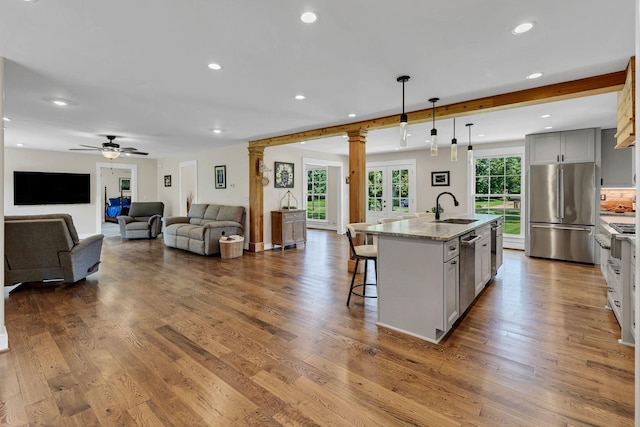 9003 Oden Ct, Brentwood, TN 37027 - kitchen with stainless steel appliances, gray cabinetry, a breakfast bar area, recessed lighting, and dark wood-style flooring