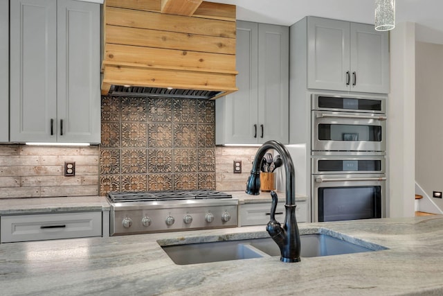 9003 Oden Ct, Brentwood, TN 37027 - kitchen featuring premium range hood, tasteful backsplash, light stone countertops, and appliances with stainless steel finishes