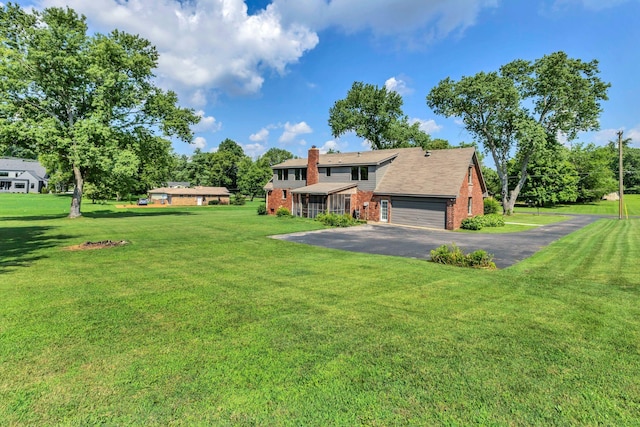 9003 Oden Ct, Brentwood, TN 37027 - view of front facade with brick siding, driveway, a front lawn, a chimney, and a garage