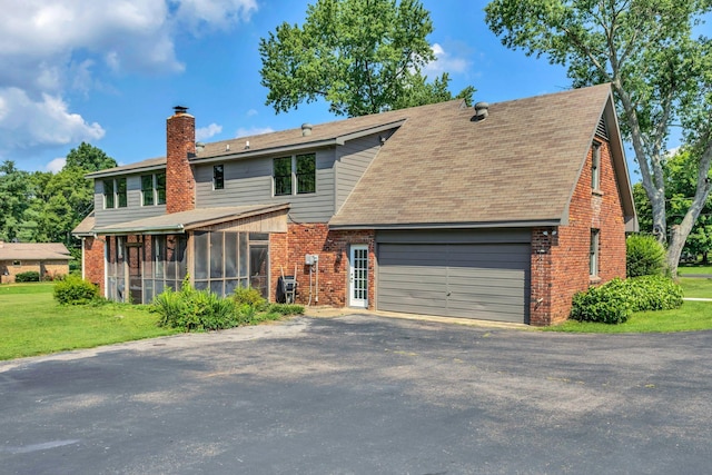 9003 Oden Ct, Brentwood, TN 37027 - view of front of property with a chimney, brick siding, asphalt driveway, and a sunroom