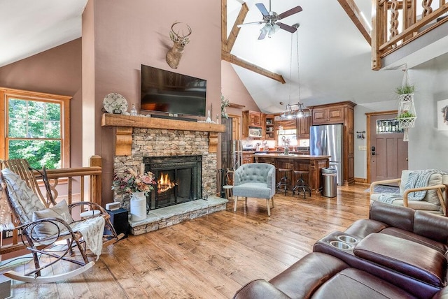 647 Omega Dr, Spring City, TN 37381 - living room with high vaulted ceiling, ceiling fan, light wood finished floors, a fireplace, and beam ceiling